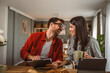 © Miljan Živković - Couple prepare documents for work have coffee and breakfast at home