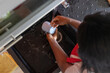 © Anna Berkut/Stocksy - closeup woman washing dishes in sink in kitchen, view from above