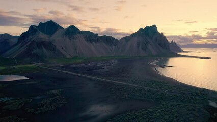 Wall Mural - Sunrise over Vestrahorn mountain with grass on black sand beach in summer at Stokksnes peninsula, Iceland