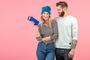 Wall Mural - young attractive couple listening to music on wireless speaker