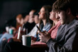 © Sean Locke/Stocksy - Movies: Male Teen Uses Cell Phone During Movie