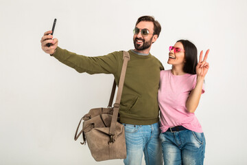 Wall Mural - couple smiling woman and man in sweatshirt with travel bag