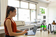 © Leonardo Borges Nuñez/Stocksy - Busy lab technician working with laptop in bright lab room