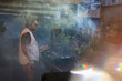 © Luciano Spinelli/Stocksy - Casual DJ playing at open-air party surrounded by plants and smoke