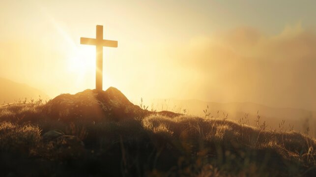 cross on top of mountain with fog and sunlight