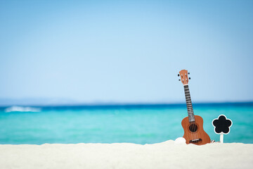 Sticker - A beautiful guitar on the sand by the Greek sea