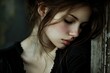 © ylivdesign - Beautiful young woman with closed eyes leaning against a wall is feeling sad