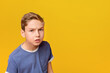 © Prostock-studio - Thoughtful dissatisfied curious teen boy closeup portrait, orange studio background