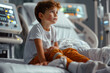 © kossovskiy - Child with leg injury in hospital bed
