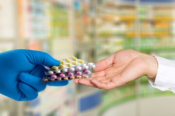 Sticker - hands of pharmacist and customer hold medicine in the drugstore