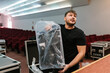 © Ezequiel Giménez/Stocksy - Man standing with LED panel in plastic pack
