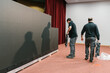 © Ezequiel Giménez/Stocksy - Men engineers carrying LED display panels on stage