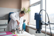 © Hernandez & Sorokina/Stocksy - Researcher Opening Beakers Of Lab Equipment For Textile Dyeing