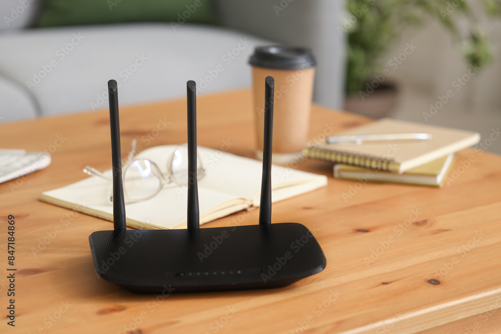 Modern wi-fi router on table in living room, closeup