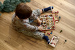 © Iuliia Versta/Stocksy - little kid playing with Christmas toys
