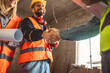 © Mediteraneo - Contractor.Construction worker team hands shaking after plan project contract  at construction site, contractor, engineering, partnership, construction concept