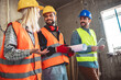 © Mediteraneo - Construction team planning a building blueprint project on site with collaboration for architect innovation. Architecture, design and engineers with teamwork for successful