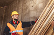 © Mediteraneo - Construction worker carrying a scaffolding at a building site - people at work concepts