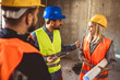 © Mediteraneo - Construction team planning a building blueprint project on site with collaboration for architect innovation. Architecture, design and engineers with teamwork for successful