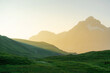 © Anna Tsukanova/Stocksy - Scenic view of green hill in Swiss Alps at sunset