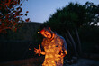 © Mal de Ojo Studio/Stocksy - Crazy Expression at Nighttime Fire
