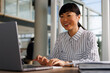 © Jovo Jovanovic/Stocksy - Businesswoman using laptop at desk in office