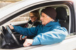 © Diego Martin/Stocksy - Senior couple sitting inside the car