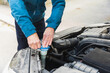 © Diego Martin/Stocksy - Hands of a senior man closing water coolant tank