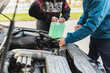 © Diego Martin/Stocksy - Senior couple putting water in coolant tank