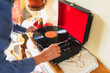 © Diego Martin/Stocksy - Close up of a senior man playing to vinyl disc at home