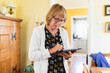 © Diego Martin/Stocksy - Senior woman at home working on a digital tablet