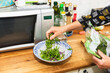 © Diego Martin/Stocksy - Senior woman preparing salad in kitchen