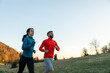 © Marko/Stocksy - Man and woman running on the mountain