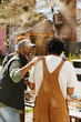 © BONNINSTUDIO/Stocksy - Diverse friends having lunch in community garden