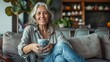 © liliyabatyrova - A woman is sitting on a couch with a cup in her hand