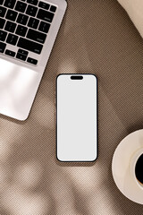 Mockup a phone with a white screen in in the morning cafe