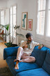 © BONNINSTUDIO/Stocksy - Man with cup of coffee using smartphone at modern flat