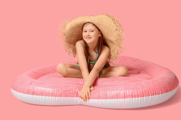 Sticker - Cute little happy girl in swimsuit with inflatable mattress sitting on pink background