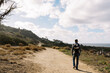© Serena Burroughs/Stocksy - young father hiking in san diego california with son in baby carrier