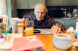 © Lea Jones/Stocksy - senior citizen taking medication and vitamins in the morning