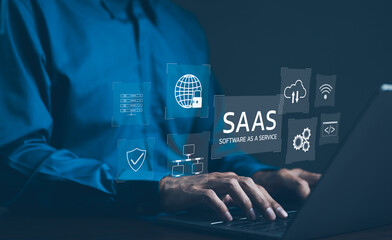 Wall Mural - saas concept, software as a service, a man types on laptop with digital icons representing various a