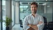 © ปฏิภาน ผดุงรัตน์ - Portrait of a cheerful businessman with folded arms standing in a conference room. Happy young businessman in shirt looking