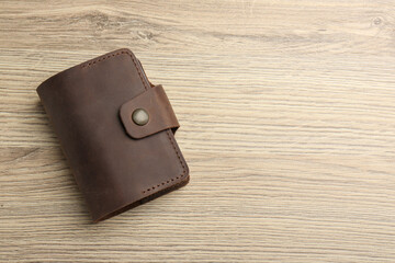 Wall Mural - Leather business card holder on wooden table, top view. Space for text