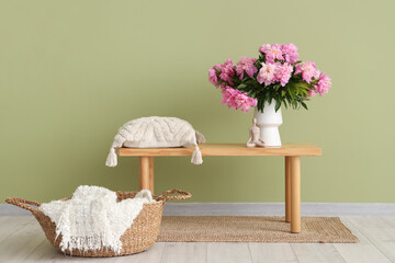 Poster - Vase with peonies flowers and pillow on bench in stylish living room