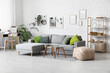 © Pixel-Shot - Living room with grey sofa, workplace, coffee table and pegboard