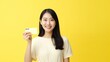 © FOXYY - photo portrait Beautiful smiling Asian woman holding credit card close up