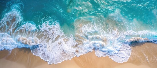 Wall Mural - Summery Beach Aerial View with Blue Waves and White Foamy Shore