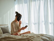 © MEM Studio/Stocksy - Woman with a face mask relaxing on a bed