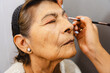 © Mal de Ojo Studio/Stocksy - Close-up of Senior Woman's Makeup Session