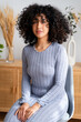 © nomad studio/Stocksy - woman sitting indoors